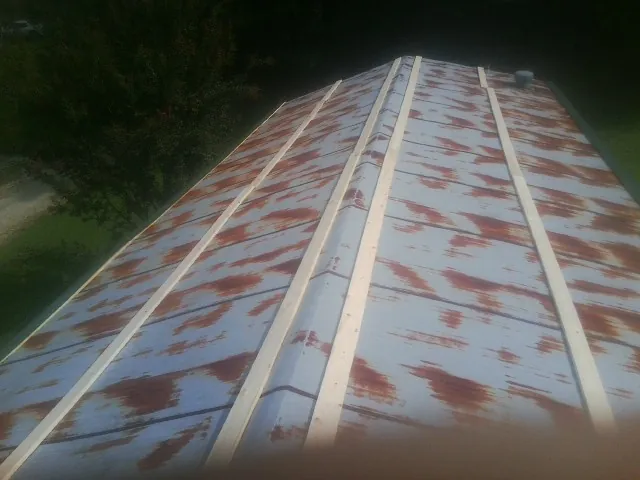 Rusted metal roof panels with new wood purlins before replacement — Storm Damage Roof Repair in Klingerstown by Roofing Brothers