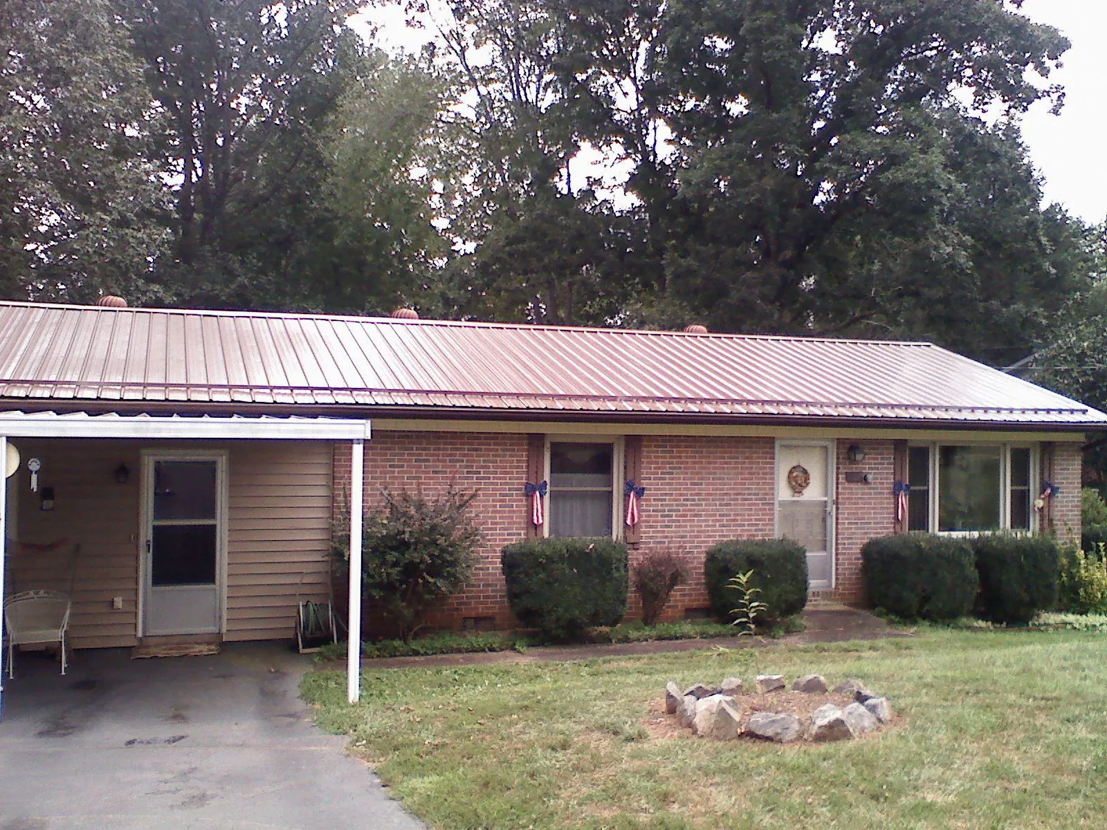 Bronze metal roof and carport on a brick ranch home — Roof Repair work by our crew in Klingerstown